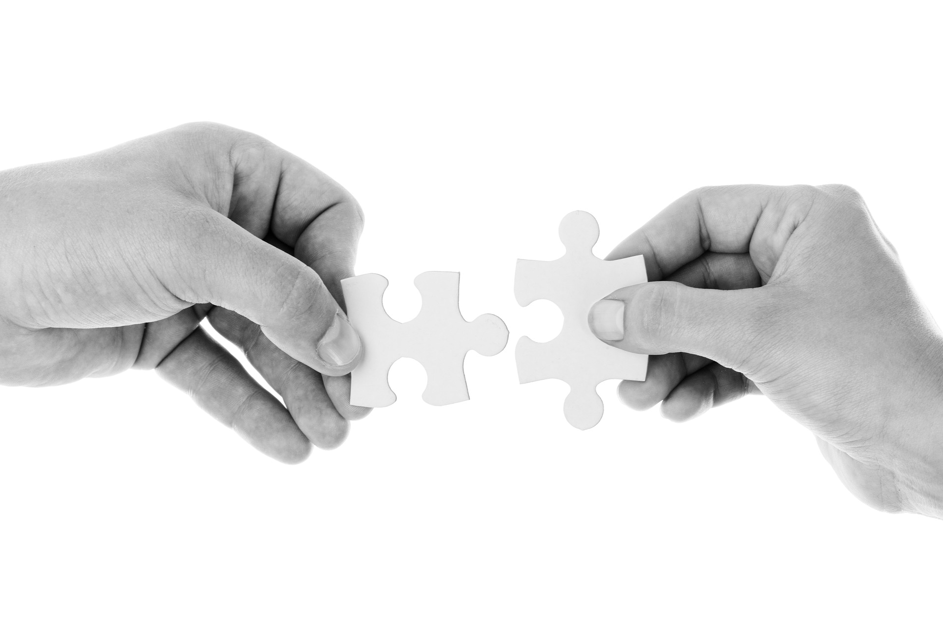 image of two people connecting 2 puzzles pieces
